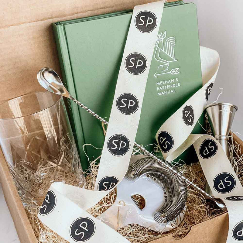 Wassail mulling spices, pepper jelly and a bar set for the holiday host