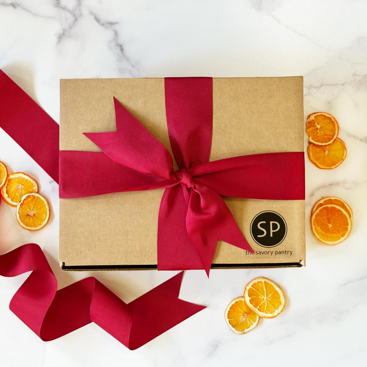 Savory Pantry holiday gift boxes, cocktail kits and gift tins arranged on a table